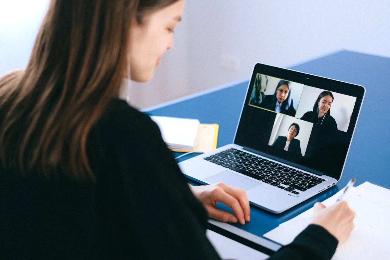 Modern corporate conference room with diverse professionals engaged in video conference meeting